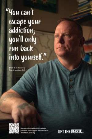 Man sitting at a desk. Image text reads, "You can't escape your addiction, you'll only run back into yourself."